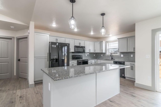 198 Michaels Dr, Hollister, MO 65672 - kitchen featuring black appliances, tasteful backsplash, light wood-style floors, and light stone countertops