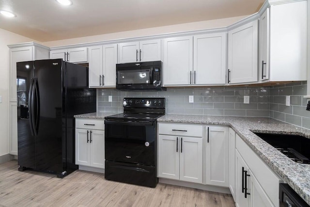 198 Michaels Dr, Hollister, MO 65672 - kitchen with black appliances, light wood-style floors, tasteful backsplash, light stone counters, and recessed lighting
