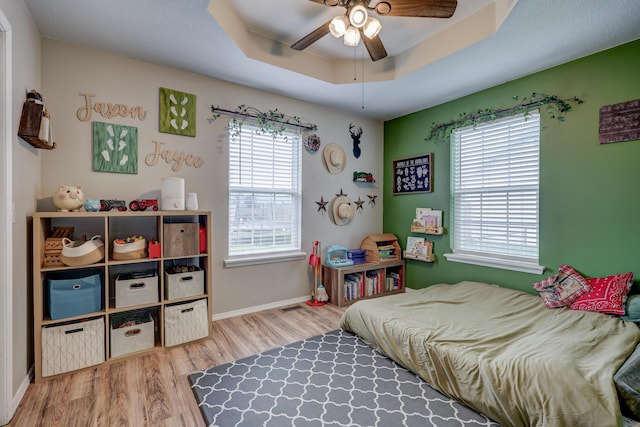 307 Azalea St, Duenweg, MO 64841 - bedroom with wood finished floors, multiple windows, baseboards, and a raised ceiling
