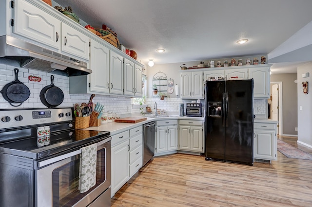 307 Azalea St, Duenweg, MO 64841 - kitchen with stainless steel appliances, under cabinet range hood, light countertops, decorative backsplash, and a sink