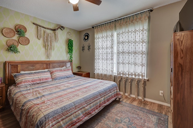307 Azalea St, Duenweg, MO 64841 - bedroom featuring wood finished floors, baseboards, a ceiling fan, and wallpapered walls