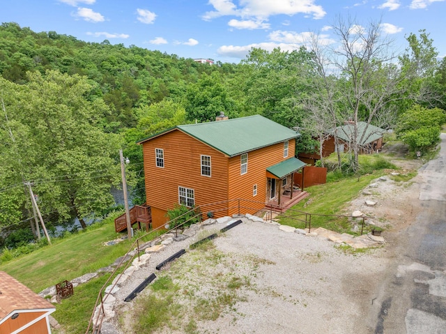 721 Shore Rd, Powersite, MO 65731 - view of home's exterior with driveway, a wooden deck, stairs, a forest view, and a chimney