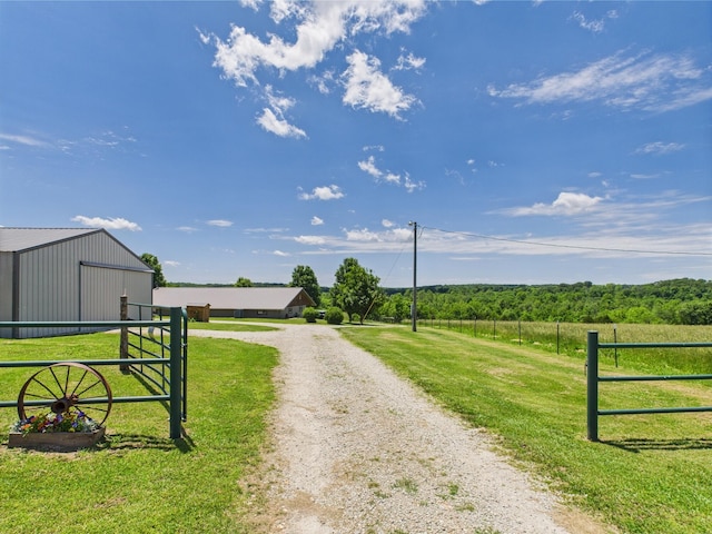 14164 Holmes Rd, Cabool, MO 65689 - view of dirt / gravel road with an outbuilding, a rural view, and a gated entry