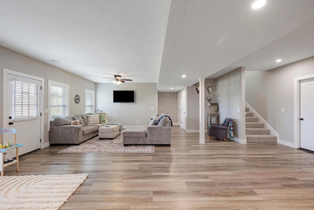 2025 Diego Ct, Bolivar, MO 65613 - living room with stairway, a ceiling fan, light wood-style floors, baseboards, and recessed lighting