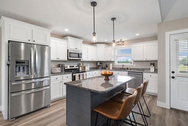 2025 Diego Ct, Bolivar, MO 65613 - kitchen featuring stainless steel appliances, wood finished floors, a sink, white cabinetry, and recessed lighting