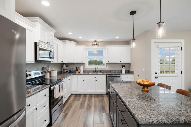 2025 Diego Ct, Bolivar, MO 65613 - kitchen featuring appliances with stainless steel finishes, light wood-style flooring, white cabinetry, a kitchen island, and recessed lighting