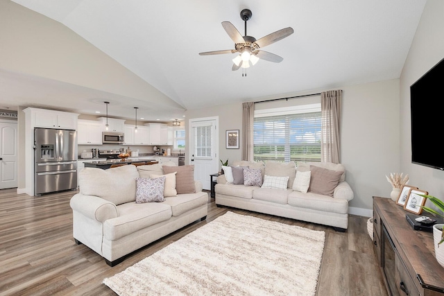 2025 Diego Ct, Bolivar, MO 65613 - living room with vaulted ceiling, light wood-style flooring, healthy amount of natural light, a ceiling fan, and baseboards