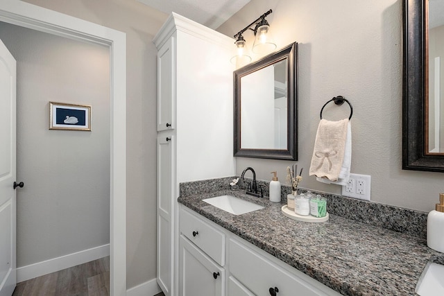 2025 Diego Ct, Bolivar, MO 65613 - bathroom with vanity, wood finished floors, and baseboards