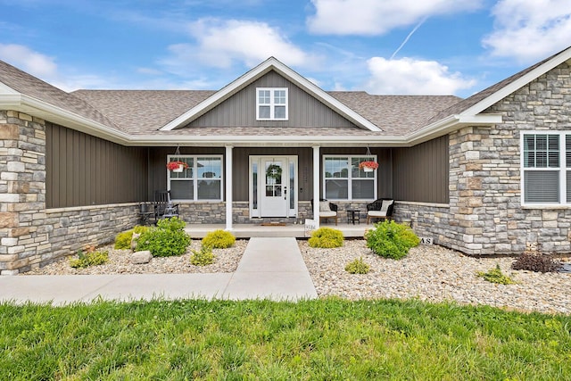 2025 Diego Ct, Bolivar, MO 65613 - entrance to property with stone siding, a shingled roof, covered porch, and board and batten siding