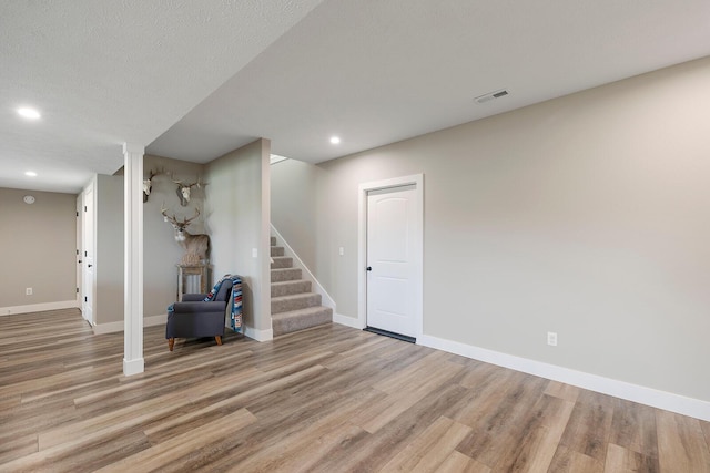 2025 Diego Ct, Bolivar, MO 65613 - finished below grade area featuring light wood-style flooring, baseboards, stairs, and recessed lighting