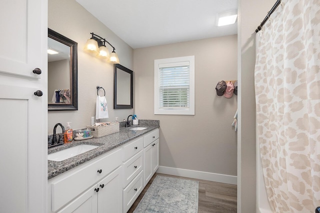 2025 Diego Ct, Bolivar, MO 65613 - full bath featuring double vanity, wood finished floors, baseboards, and a shower with shower curtain