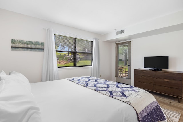 128 Bunker Ridge Rd Unit 2, Branson, MO 65616 - bedroom featuring wood finished floors and access to outside