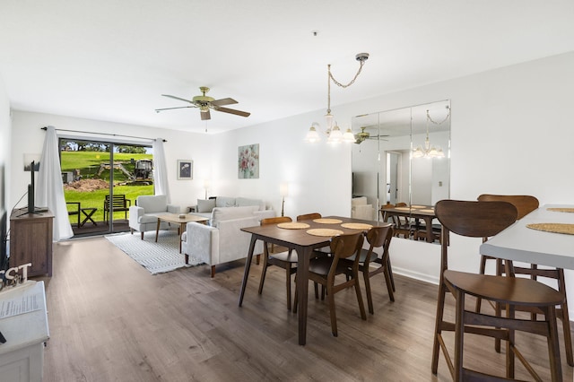 128 Bunker Ridge Rd Unit 2, Branson, MO 65616 - dining room with wood finished floors, a chandelier, and a ceiling fan