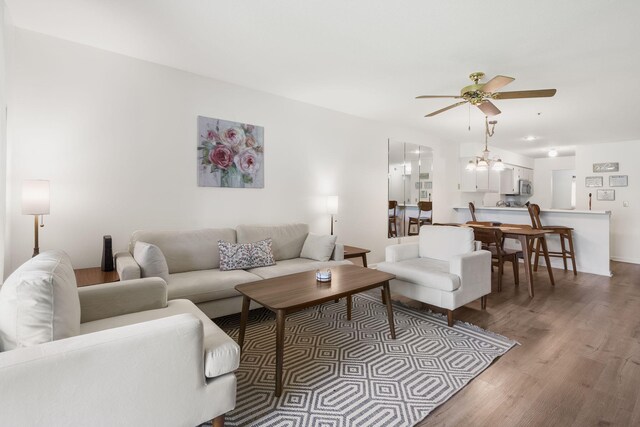 128 Bunker Ridge Rd Unit 2, Branson, MO 65616 - living area featuring ceiling fan, wood finished floors, and a chandelier