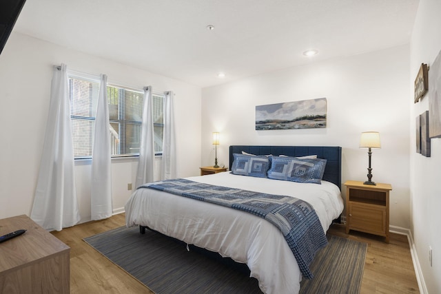 128 Bunker Ridge Rd Unit 2, Branson, MO 65616 - bedroom with light wood finished floors, baseboards, and recessed lighting
