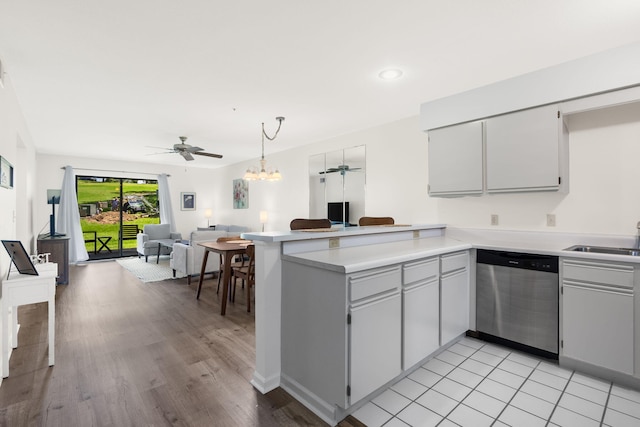128 Bunker Ridge Rd Unit 2, Branson, MO 65616 - kitchen featuring stainless steel dishwasher, open floor plan, a sink, a peninsula, and a ceiling fan