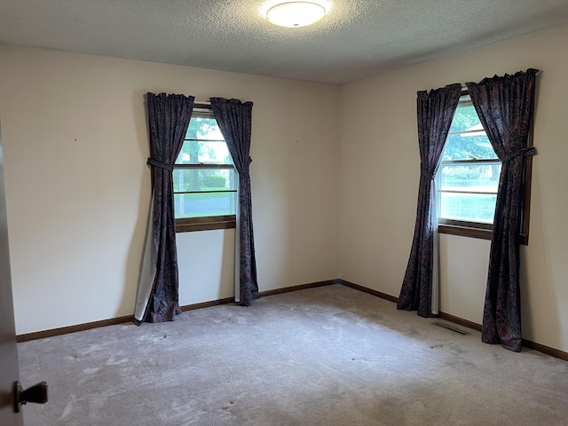 641 N Claud Ave, Bolivar, MO 65613 - spare room with a textured ceiling, carpet floors, and baseboards