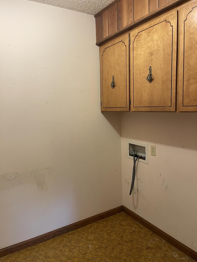 641 N Claud Ave, Bolivar, MO 65613 - laundry area with cabinet space, hookup for a washing machine, a textured ceiling, and baseboards
