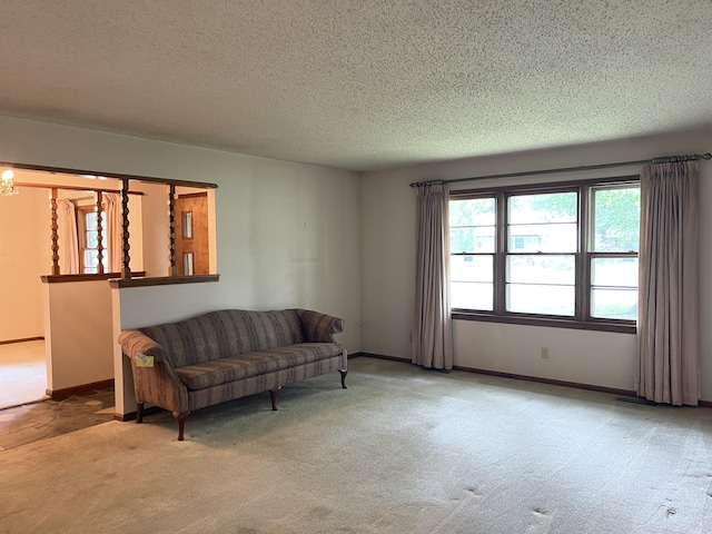 641 N Claud Ave, Bolivar, MO 65613 - carpeted living area featuring plenty of natural light, a textured ceiling, and baseboards