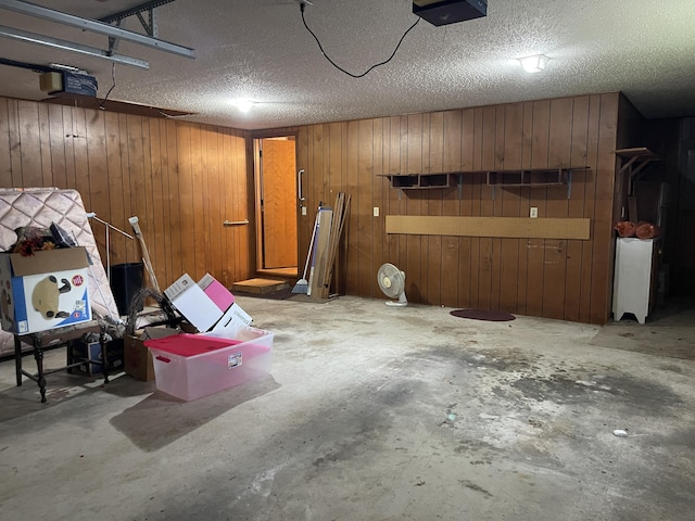 641 N Claud Ave, Bolivar, MO 65613 - garage featuring a garage door opener and wooden walls