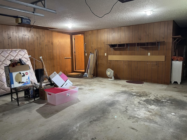 641 N Claud Ave, Bolivar, MO 65613 - garage featuring wood walls and a garage door opener