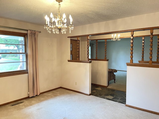 641 N Claud Ave, Bolivar, MO 65613 - empty room with carpet, a chandelier, a textured ceiling, and baseboards