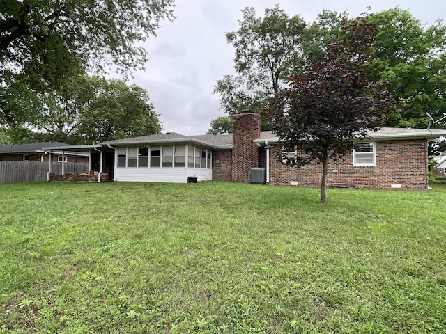 641 N Claud Ave, Bolivar, MO 65613 - rear view of house featuring a chimney, brick siding, and central air condition unit