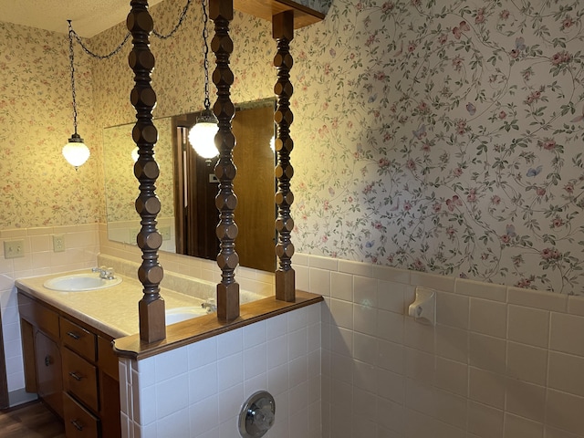 641 N Claud Ave, Bolivar, MO 65613 - bathroom featuring wallpapered walls, vanity, wainscoting, and tile walls