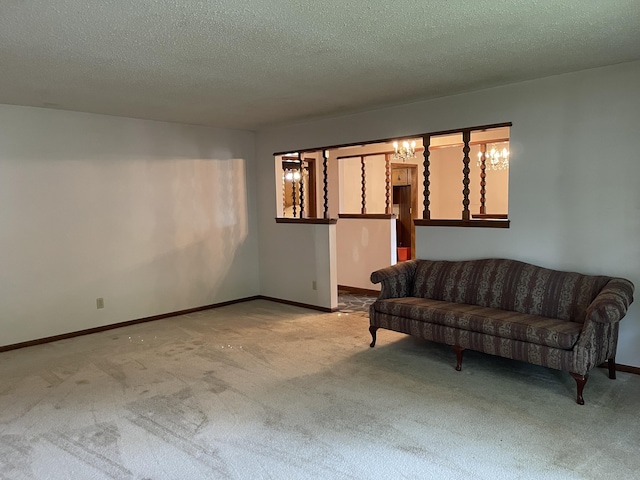641 N Claud Ave, Bolivar, MO 65613 - living room with carpet floors, baseboards, a textured ceiling, and a chandelier