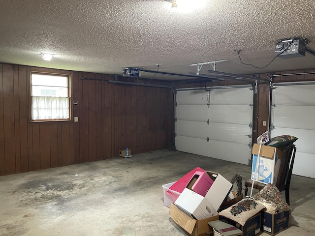 641 N Claud Ave, Bolivar, MO 65613 - garage featuring a garage door opener and wooden walls