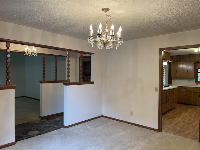 641 N Claud Ave, Bolivar, MO 65613 - unfurnished dining area featuring carpet floors, a chandelier, baseboards, and a textured ceiling