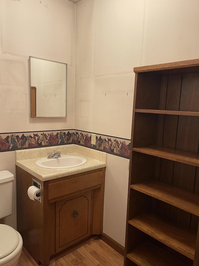 641 N Claud Ave, Bolivar, MO 65613 - half bathroom featuring toilet, vanity, and wood finished floors