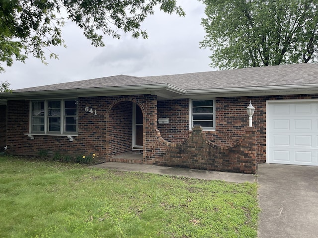 641 N Claud Ave, Bolivar, MO 65613 - ranch-style house with brick siding, a garage, driveway, and a front lawn