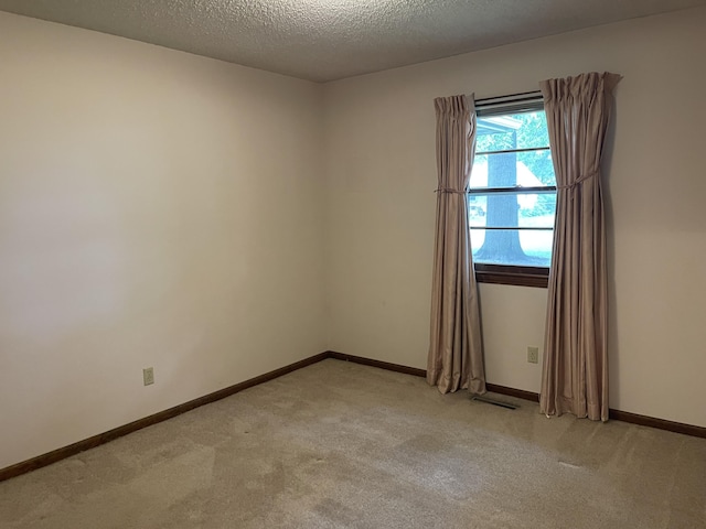 641 N Claud Ave, Bolivar, MO 65613 - empty room with light colored carpet, a textured ceiling, and baseboards
