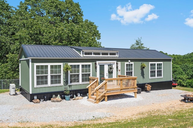 132 Nature Trail Ln, Noel, MO 64854 - view of front of house with metal roof, a fire pit, and french doors