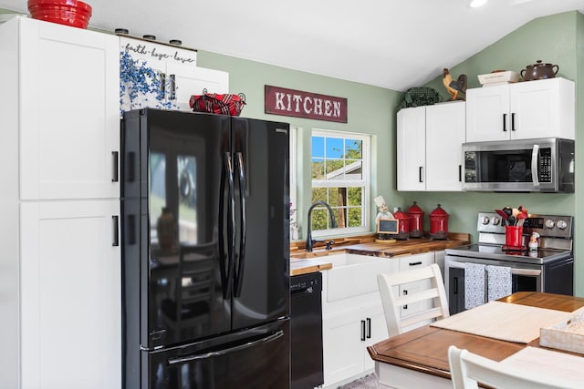132 Nature Trail Ln, Noel, MO 64854 - kitchen featuring black appliances, wooden counters, vaulted ceiling, white cabinetry, and a sink