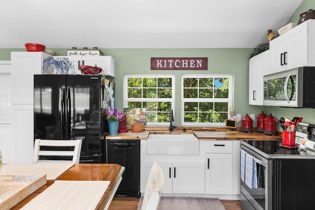 132 Nature Trail Ln, Noel, MO 64854 - kitchen with black appliances, a sink, healthy amount of natural light, and butcher block countertops
