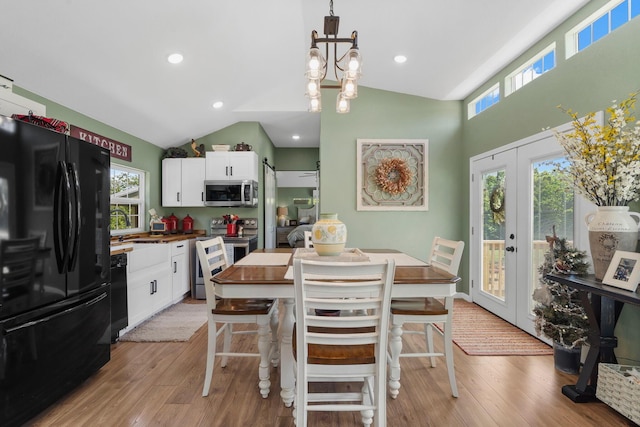 132 Nature Trail Ln, Noel, MO 64854 - kitchen featuring black appliances, light wood-style flooring, white cabinetry, plenty of natural light, and vaulted ceiling