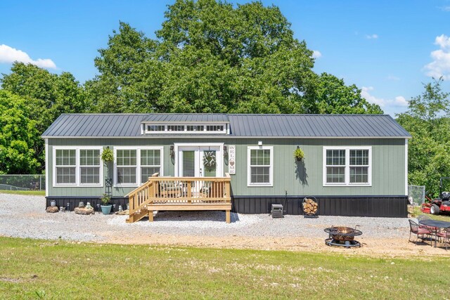 132 Nature Trail Ln, Noel, MO 64854 - rear view of house featuring an outdoor fire pit, metal roof, and a lawn