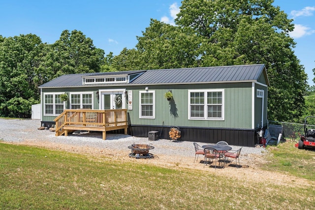 132 Nature Trail Ln, Noel, MO 64854 - rear view of property featuring a fire pit, a deck, and metal roof