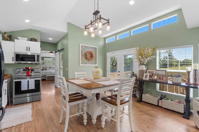 132 Nature Trail Ln, Noel, MO 64854 - dining area featuring french doors, plenty of natural light, light wood finished floors, a barn door, and high vaulted ceiling