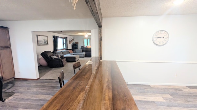 9550 S 325th Rd, El Dorado Springs, MO 64744 - dining area featuring wood finished floors, a textured ceiling, and baseboards