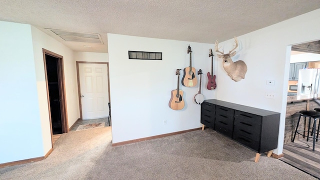9550 S 325th Rd, El Dorado Springs, MO 64744 - carpeted bedroom with white fridge with ice dispenser, a textured ceiling, and baseboards