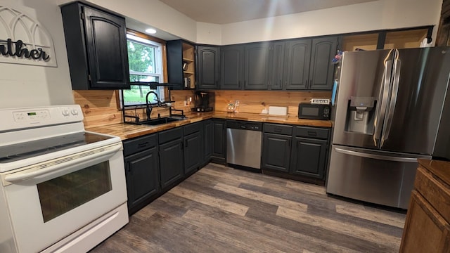 9550 S 325th Rd, El Dorado Springs, MO 64744 - kitchen with appliances with stainless steel finishes, a sink, dark wood-style flooring, open shelves, and backsplash