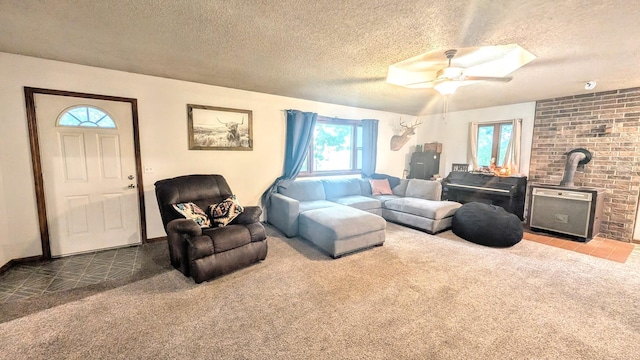 9550 S 325th Rd, El Dorado Springs, MO 64744 - living area with a wood stove, carpet, a textured ceiling, and ceiling fan