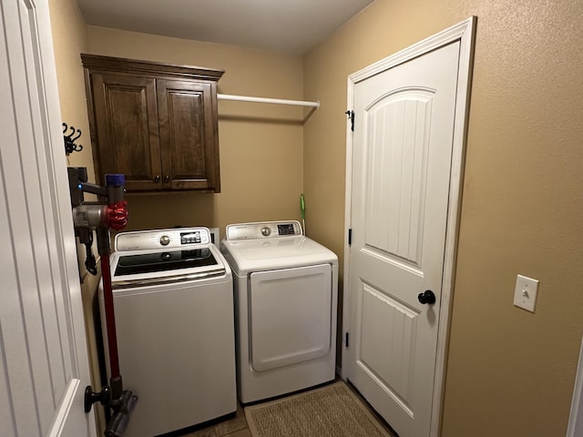 2818 E 16th St, Joplin, MO 64804 - laundry room with washer and dryer, cabinet space, and tile patterned flooring