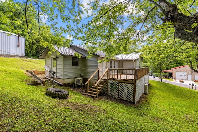 305 S Rock Ave, Mansfield, MO 65704 - rear view of house with a deck, metal roof, a yard, and a garage