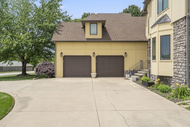 3909 W Eaglecrest St, Battlefield, MO 65619 - view of front of property featuring stone siding, a garage, driveway, stucco siding, and a shingled roof