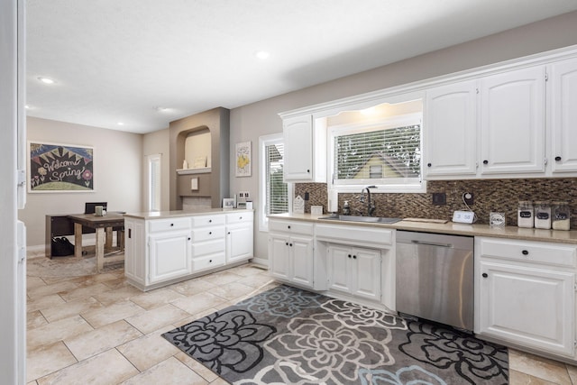 3909 W Eaglecrest St, Battlefield, MO 65619 - kitchen with dishwasher, a sink, decorative backsplash, light countertops, and white cabinets