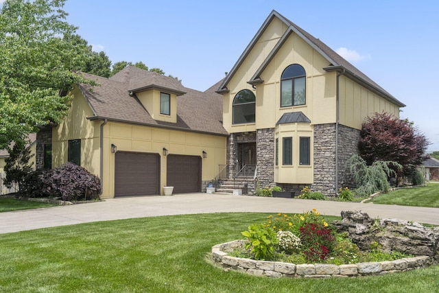 3909 W Eaglecrest St, Battlefield, MO 65619 - view of front of home with stone siding, a garage, stucco siding, driveway, and a front lawn